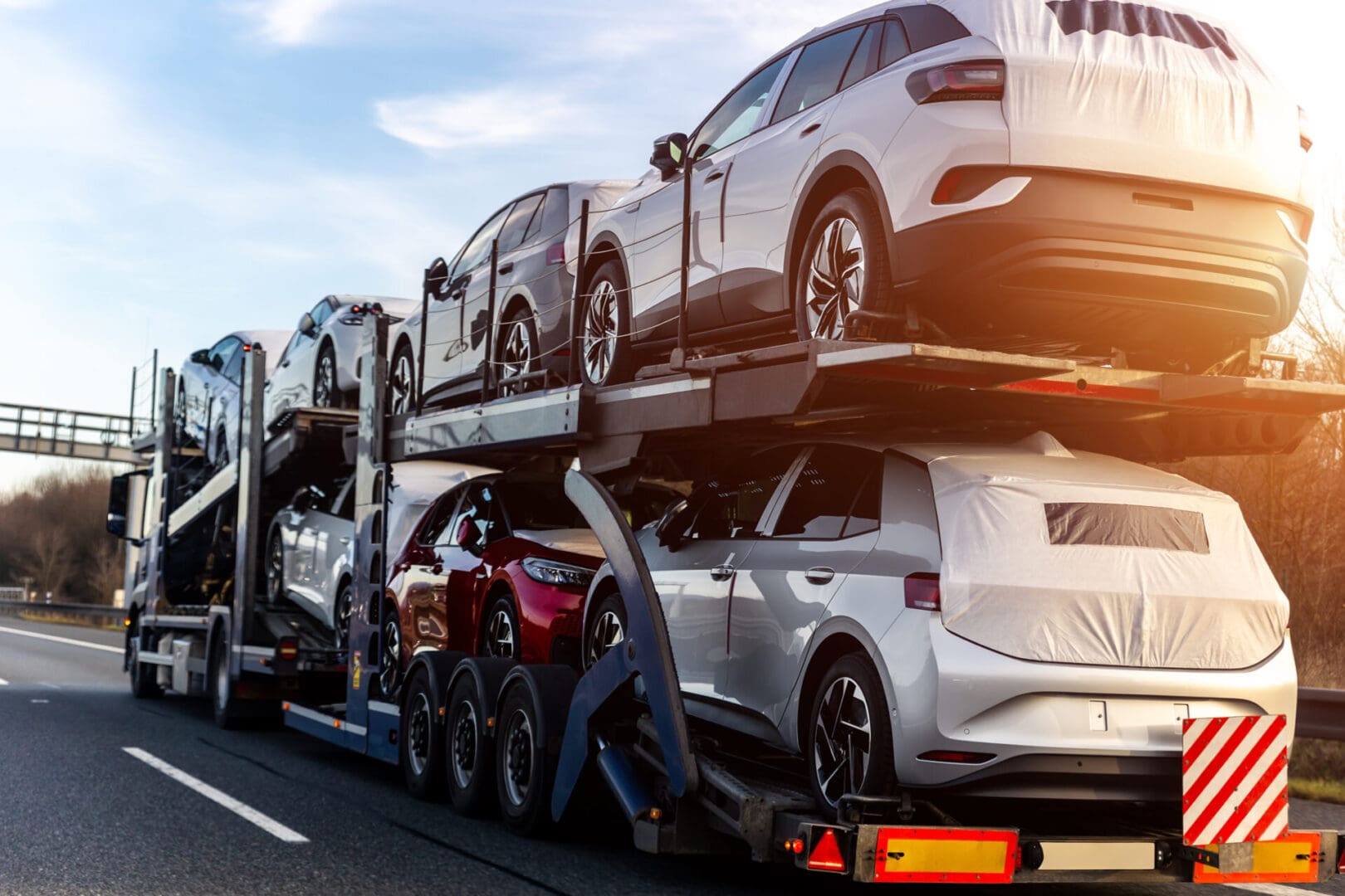 A truck carrying cars on the road